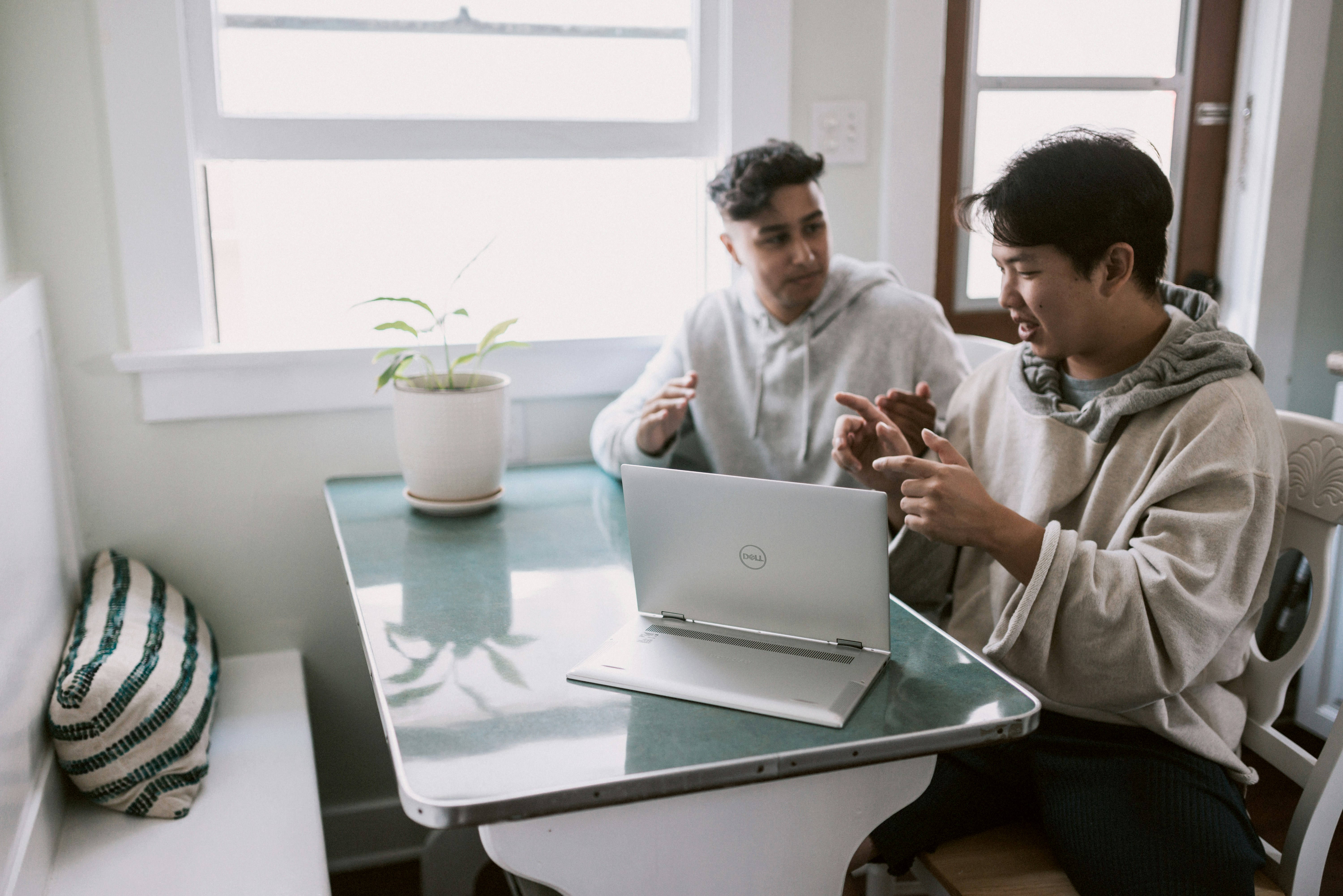 Friends working together on a laptop